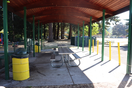 Covered shelter with picnic tables on concrete slab – reserve through the City of Wood Village – accessible parking in lot